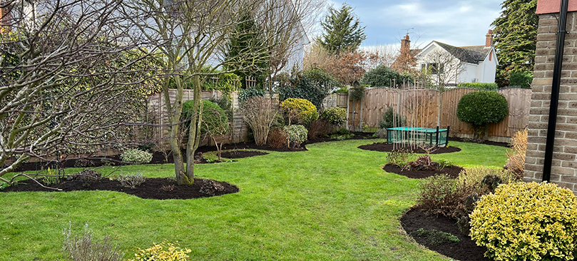 Tidy lawn and beds maintained by K&J Home Improvements